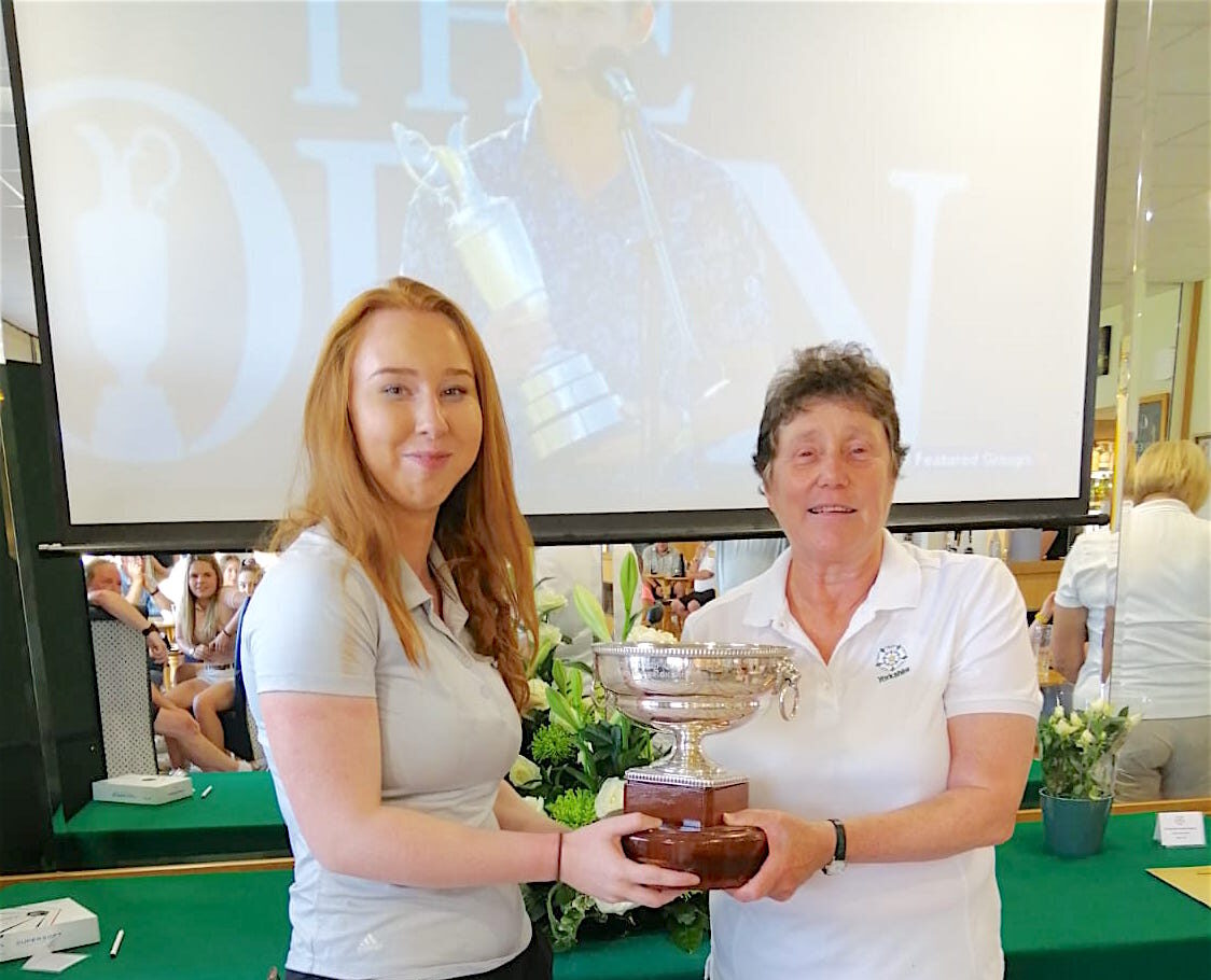 MOVE OVER COLLIN! Abigail Taylor collects the Yorkshire Girls trophy from county captain Maggie Katz. Apparently someone else was doing something similar at Royal St Georges at about the same time