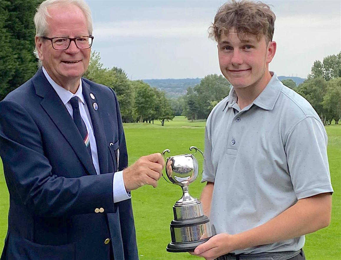 Jenson Forrester is presented with the Midlands Boys trophy by David Price, President of the Midland Golf Union