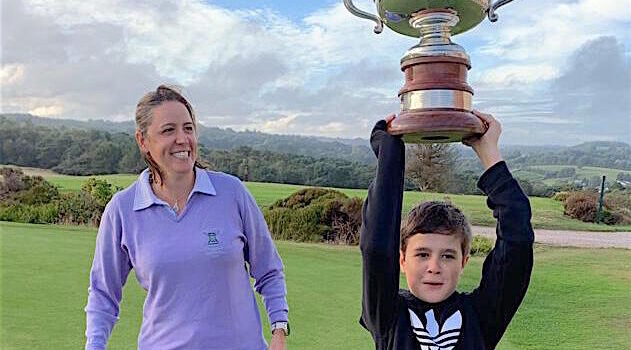 Harry Turner lifts aloft the Devon County Championship won by mum Abby