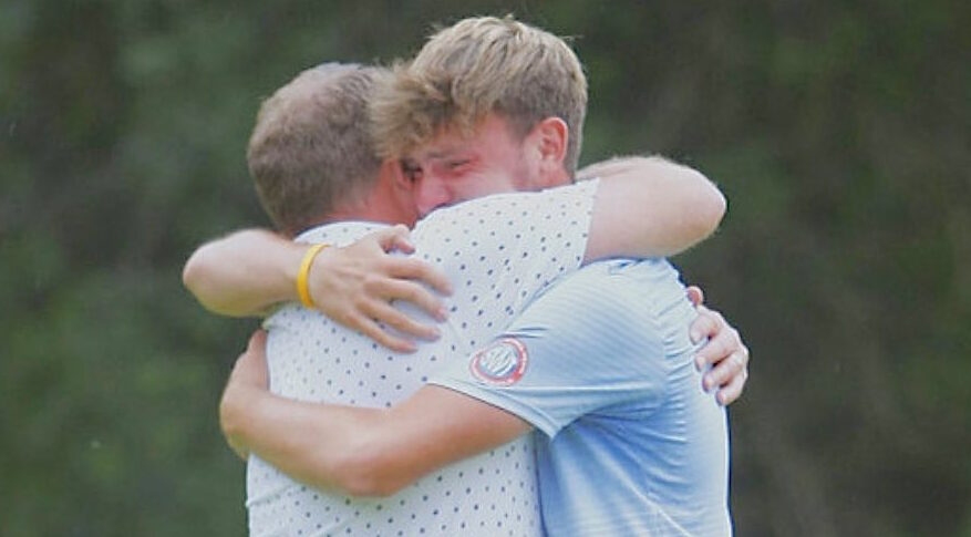 James Claridge is embraced by his dad after winning the Walton Heath Trophy