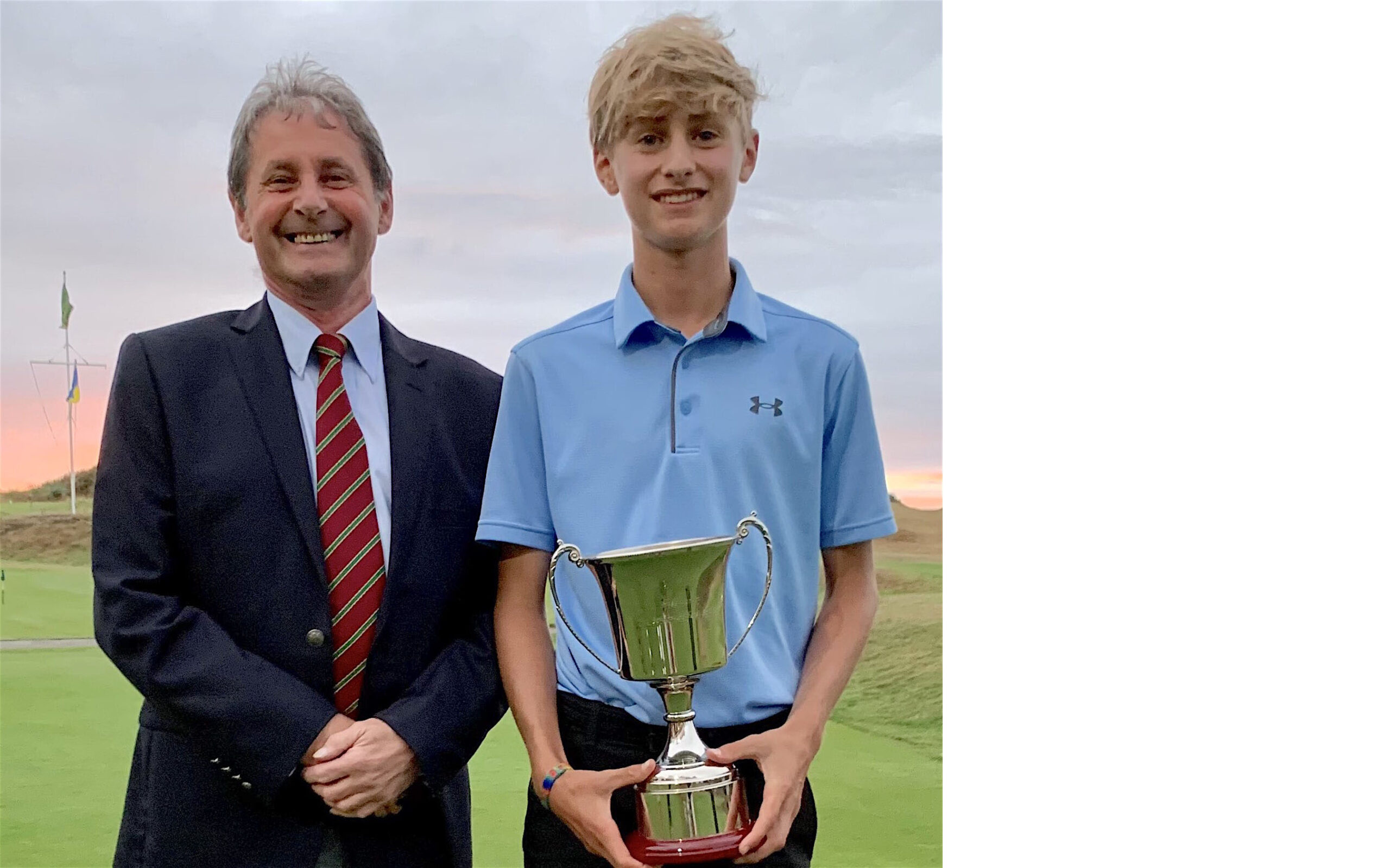 Freddie Turnell is presented with the South West U-18s title by Robin Griffiths of the Seniors Society (the organisation that started the event)
