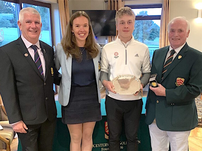 Monty Holcombe is presented with the West of England U-16s winners shield by Cotswold Hills captains Shane Hole and Claudia Ovens plus Gloucestershire county captain Steve Sheppard (far right)