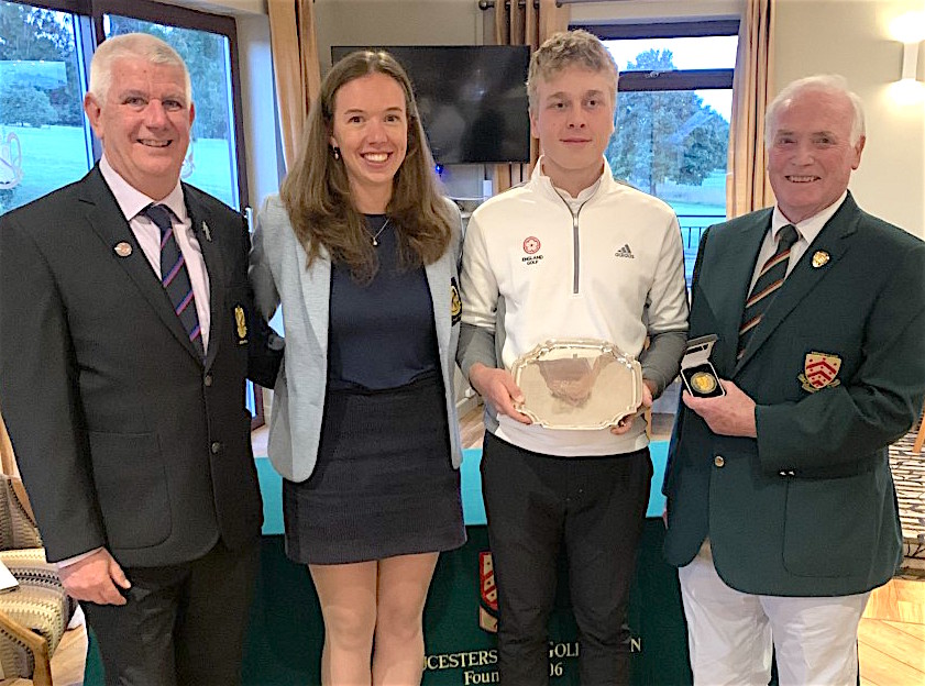Monty Holcombe is presented with the West of England U-16s winners shield by Cotswold Hills captains Shane Hole and Claudia Ovens plus Gloucestershire county captain Steve Sheppard (far right)