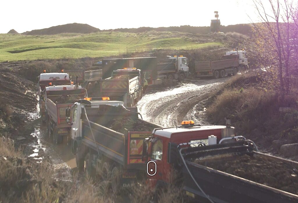 Lorries carry landfill to a golf course