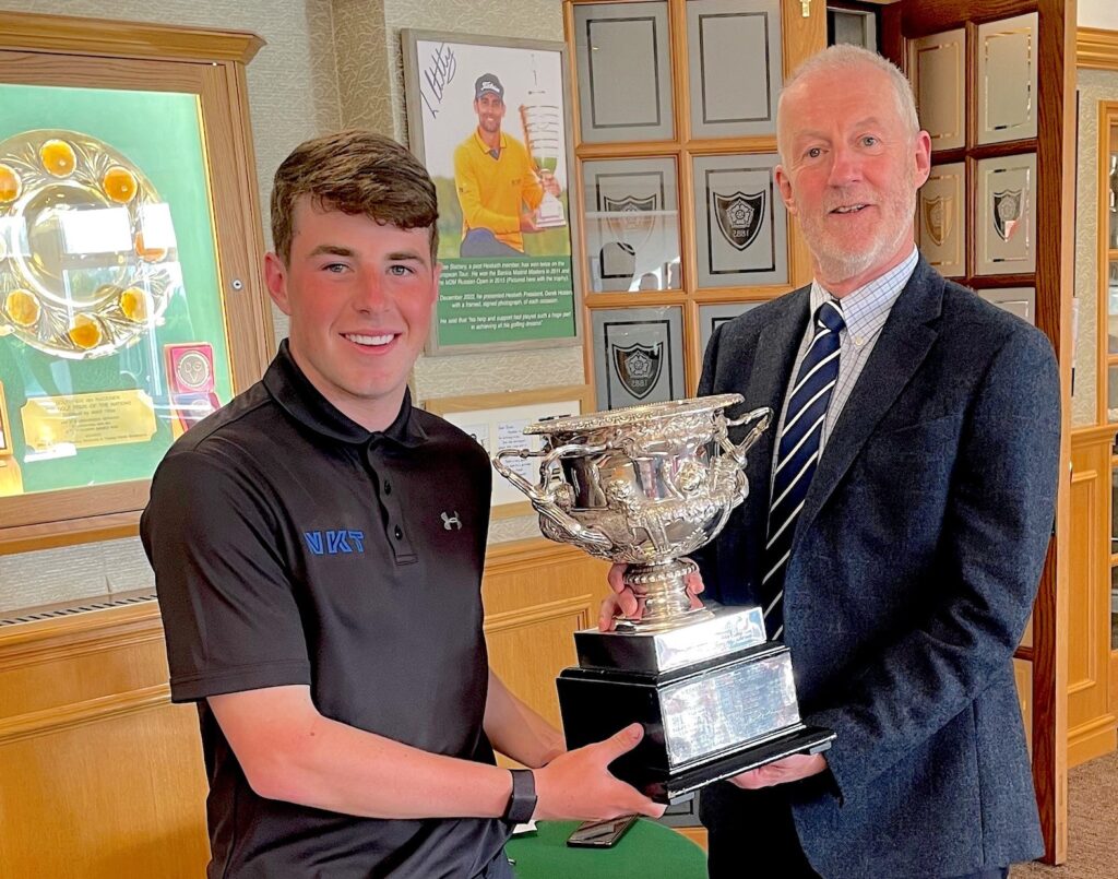 2023 Henriques Trophy champion Jack McPhail is presented with the winners trophy by captain Roger Baron