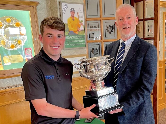 2023 Henriques Trophy champion Jack McPhail is presented with the winners trophy by captain Roger Baron